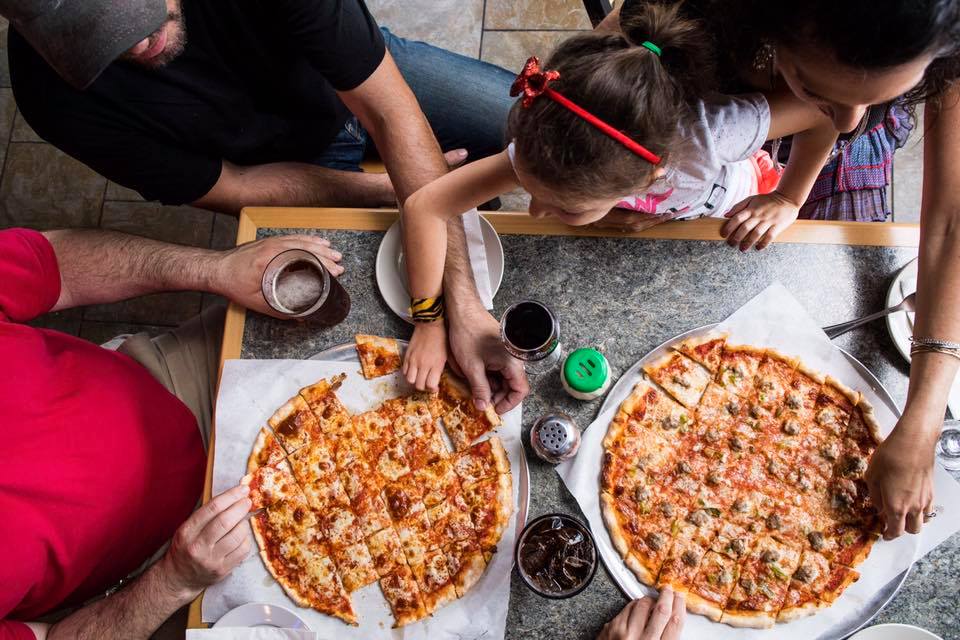 Family enjoying pizza at Sammy's